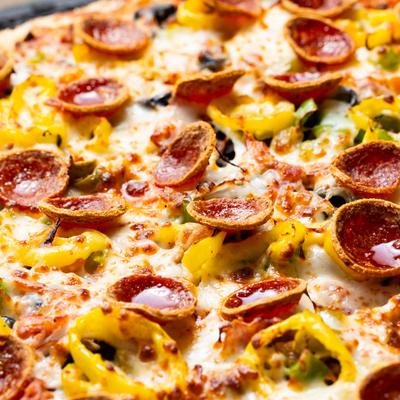 Supreme Pizza, with sausage, pepperoni, ham, mushroom, olives, onion, and peppers.