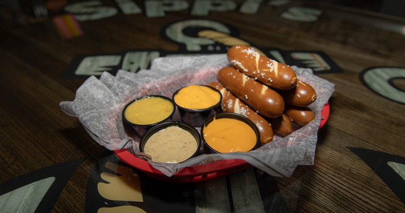 Soft pretzel served with dipping sauces