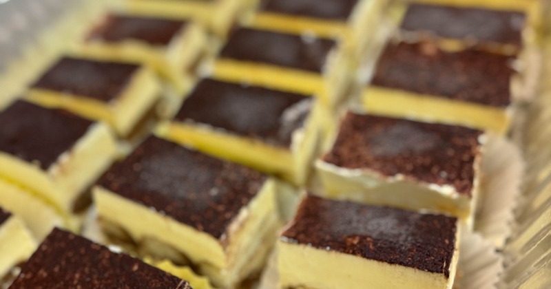 Rows of layered dessert bars on a tray