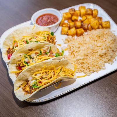 Breakfast Tacos served with rice, home style potatoes, and house made salsa.