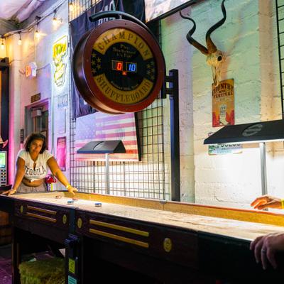 The guests play shuffleboard.