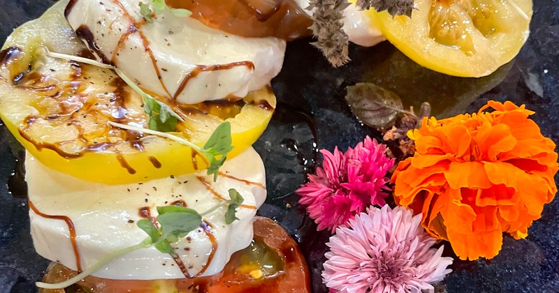 Caprese salad plate garnished with flowers