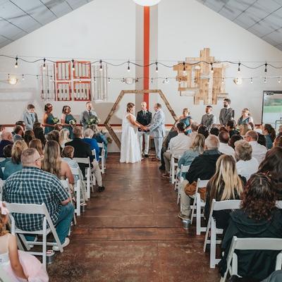Bride and groom exchanging vows in front of guests.