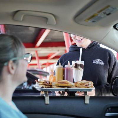 customer curb girl tray hanging on car window.