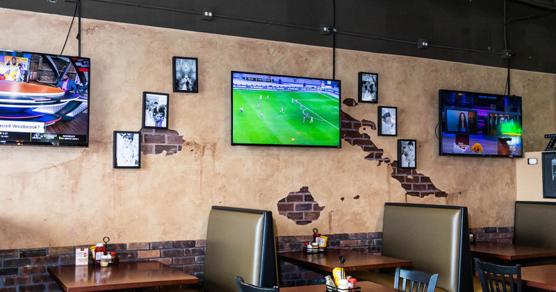 Interior walls decorated with photos and TVs hanging on them