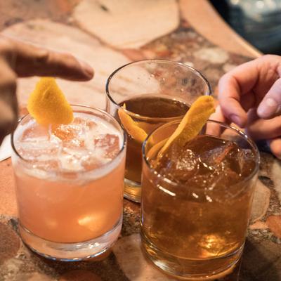 Assorted cocktails on a bar counter.