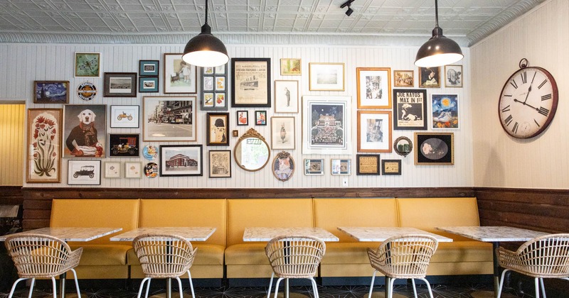 Interior, wall seating and tables with chairs, pictures on a wall