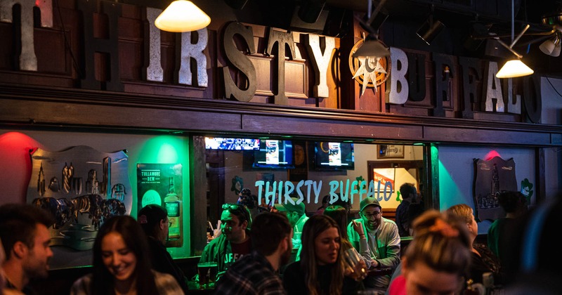 Interior, bar area, guests and sign above