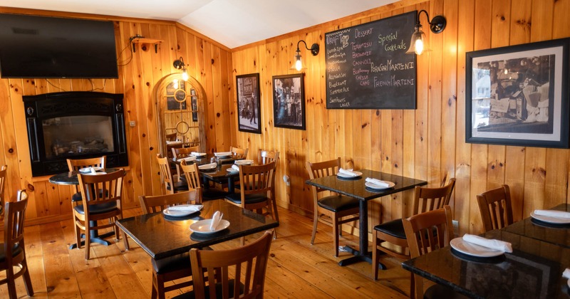 Dining area, wooden interior with paintings on the wall