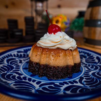 Chocolate Flan, topped with whipped cream.
