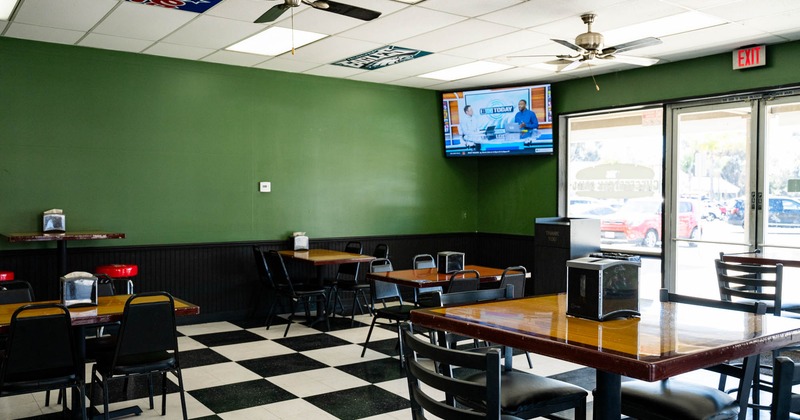 Interior, dining area, restaurant entrance, shop windows, tables for four, tile flooring