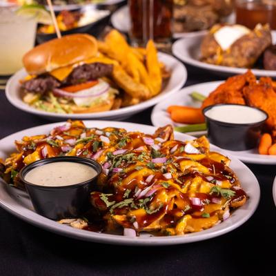 Loaded fries with cheese, barbecue sauce, and ranch dressing.