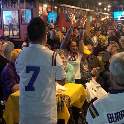 A guy in a white 7 jersey and crowd in the background