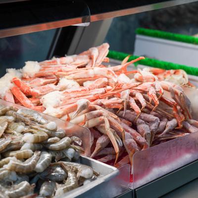 Retail seafood display case featuring various types of fresh or frozen seafood.