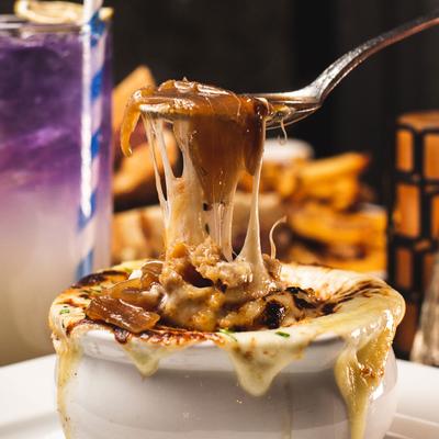 French Onion Soup, cheese pulled with a spoon