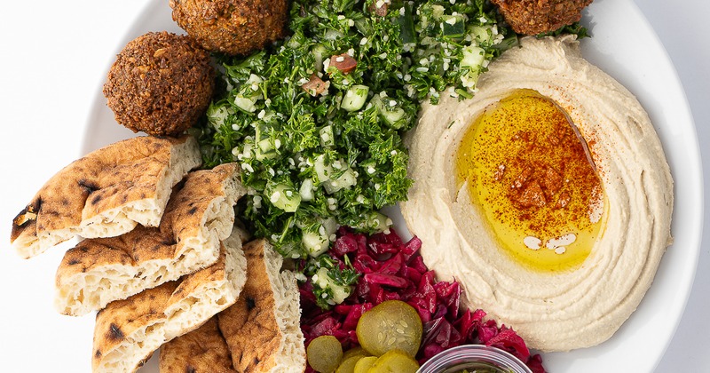 falafel platter- tabouli, hummus, red cabbage, pita, pickles, schug