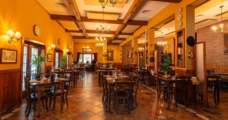 Interior, open space dining area, wooden chairs and tables, tile flooring