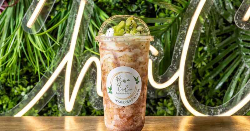 Pina Colada smoothie with kiwi fruit in a branded cup