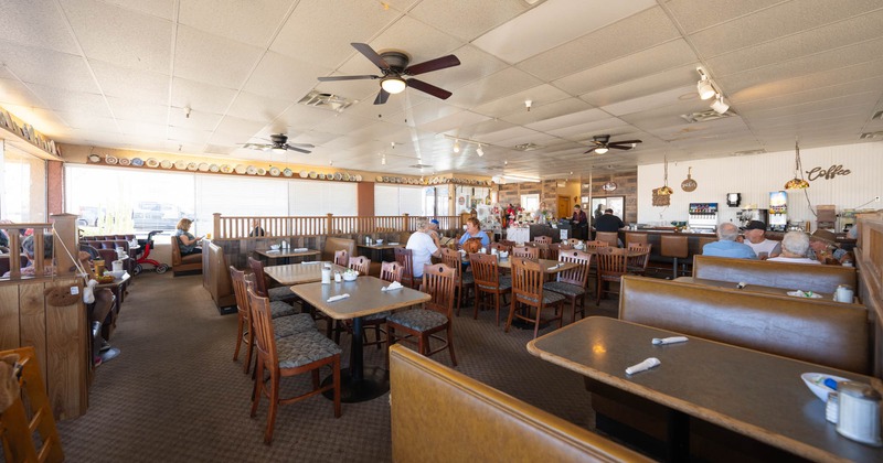 Interior, dining area with tables, chairs and restaurant booths