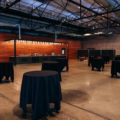 Round tables with black tablecloths.