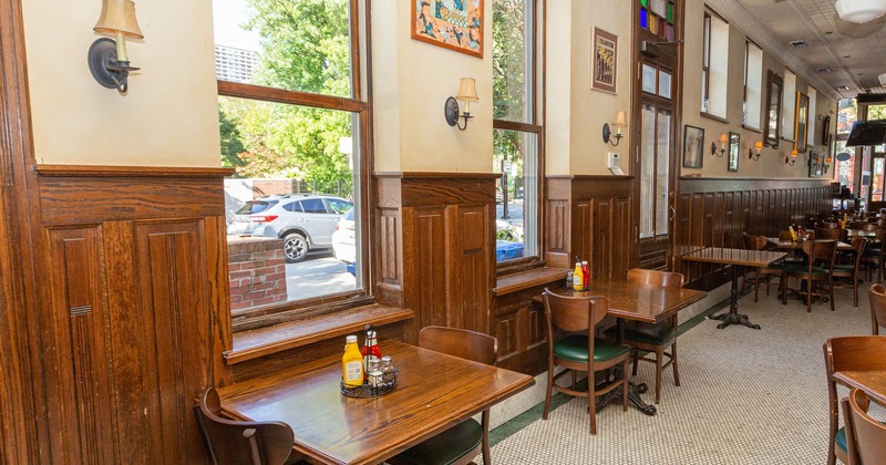 Interior, tables for two and seats by windows