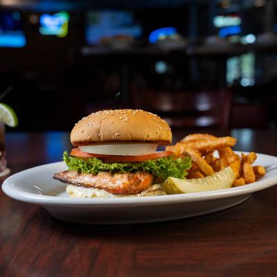 Salmon burger served with fries.
