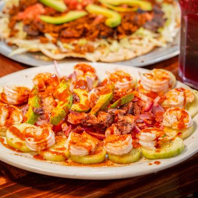 Cooked and seasoned shrimp on cucumber slices.