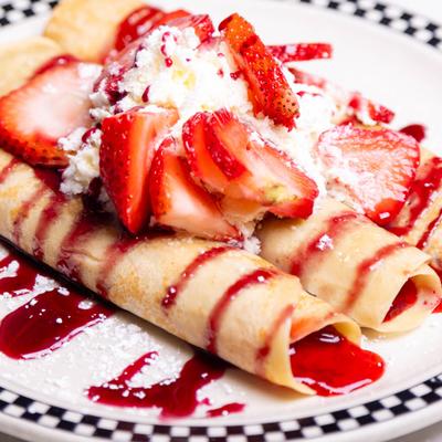 Crepes with whipped cream and strawberries.