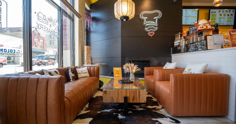 Interior, lounge area, comfy three seater sofa with two armchairts and coffee table