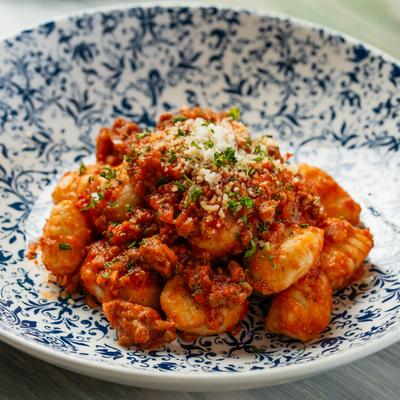 Gnocchi alla Salsiccia  House made potato dumplings, house sweet Sausage Ragu of pork, turkey, tomato, and MoMo spice blend.