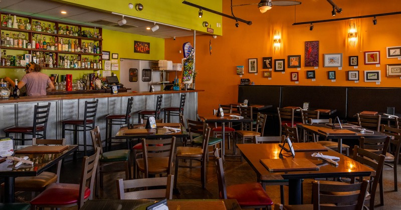 Interior, wide view of dining area, bar area on the left