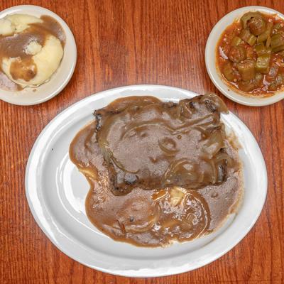 Fried steak with mashed potatoes and gravy.