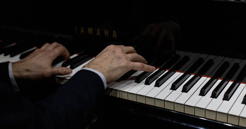 Hands playing the piano