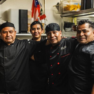 Kitchen staff members posing together.