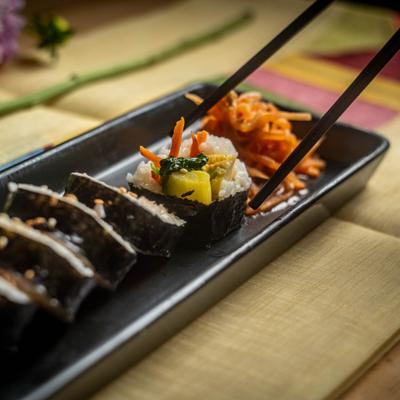 Chopsticks takind a roll from the plate.