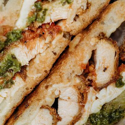 Grilled chicken with pesto, closeup.