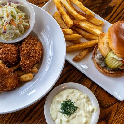 Fish and chips with coleslaw served with a burger with fries and a house-made sauce.
