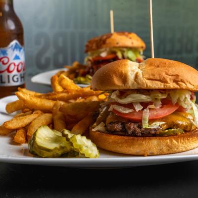 Classic cheeseburger served with pickle and fries.