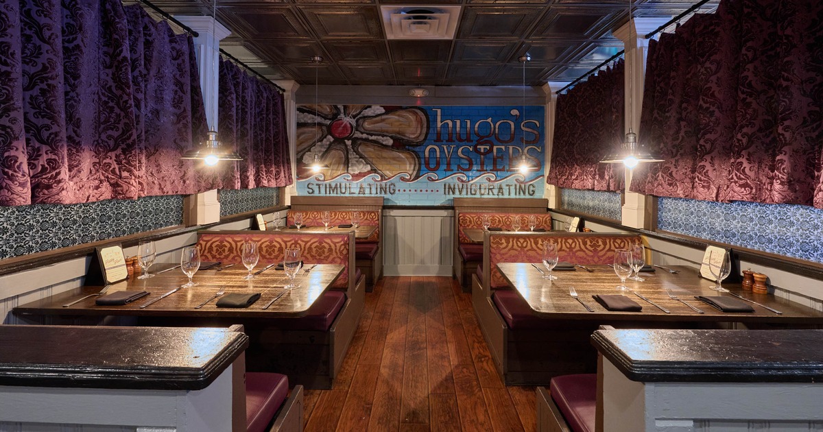 Interior seating area with wooden booths and patterned seats
