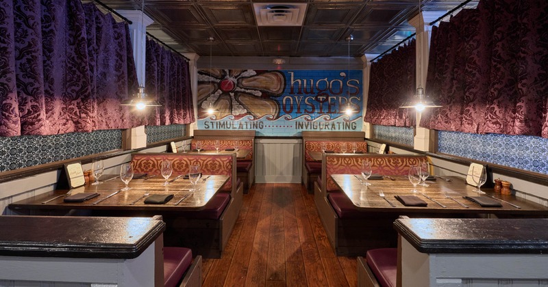 Interior seating area with wooden booths and patterned seats