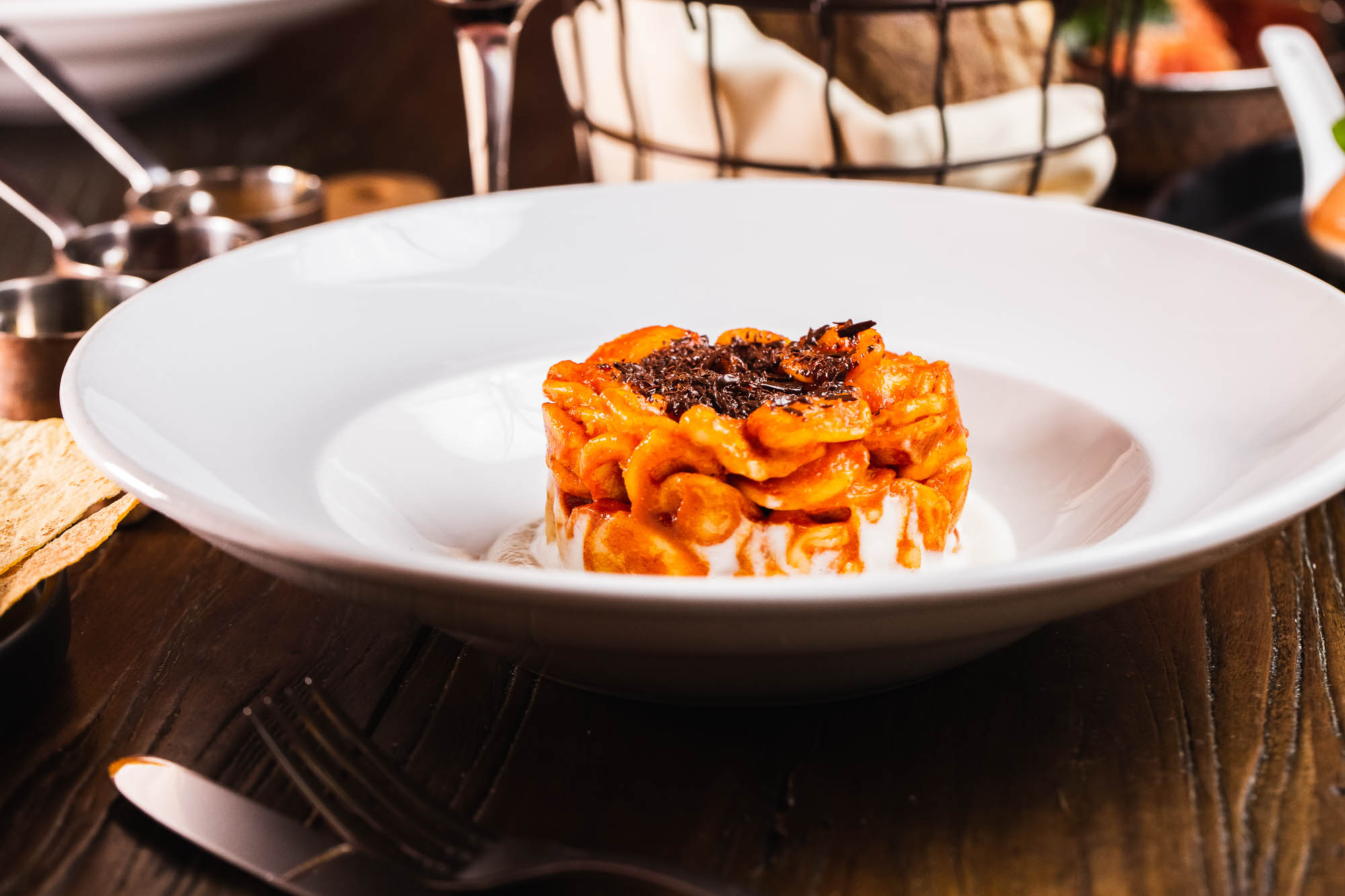 Orecchiette pasta with a spicy  'nduja sausage, cauliflower puree, and shaved chocolate