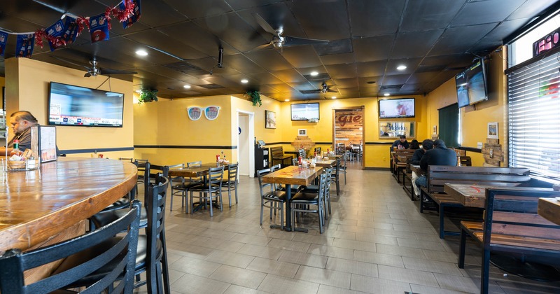 Interior, wide view, tables and chairs, guests sitting at tables