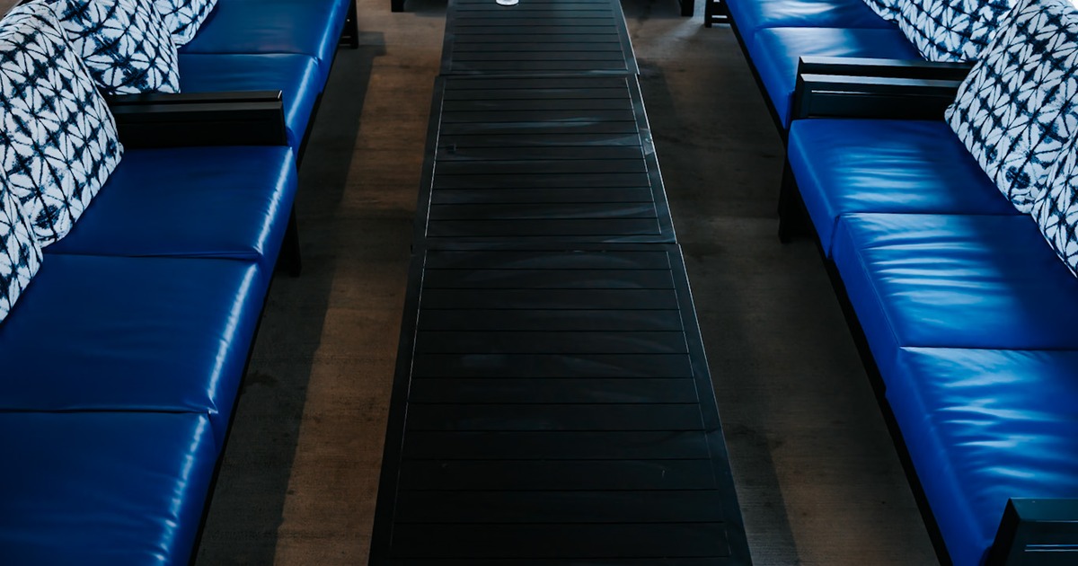 Black coffee tables and blue leather sofas