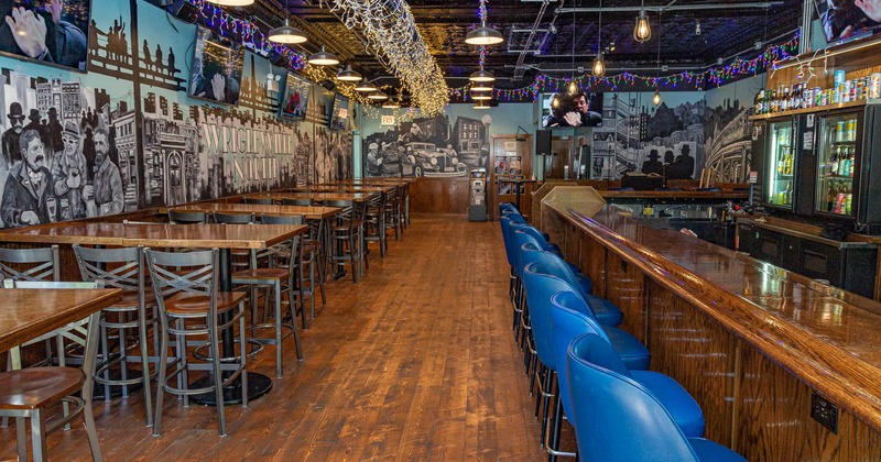 Blue bar stools lined up in front of bar counter