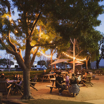 Restaurant exterior, guests sitting, drinking, having fun.
