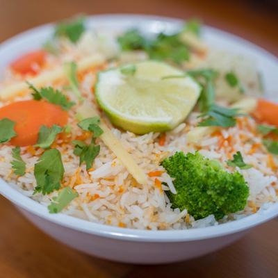 Rice with broccoli, carrots, lime, and cilantro.