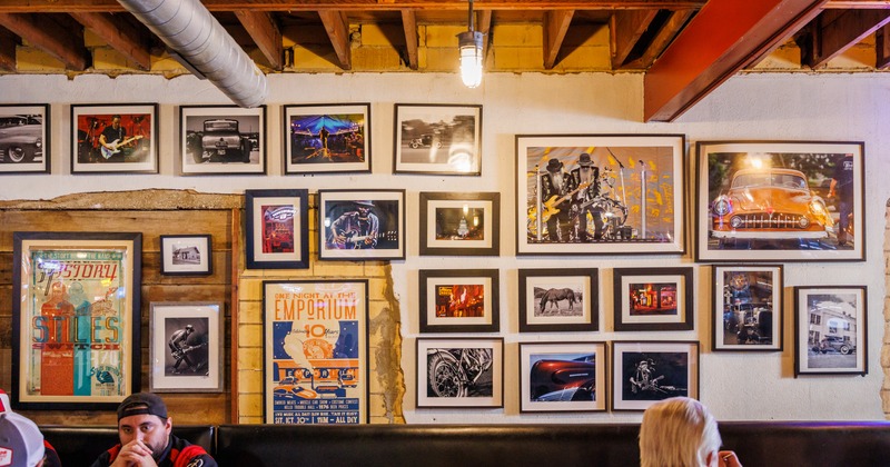 Interior, seating area, wall with framed retro pictures of cars and musicians