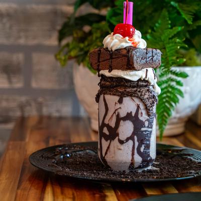 A cookie and cream milkshake with brownie.