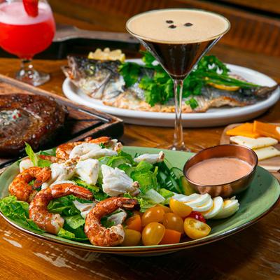Assorted dishes and cocktails on a table.