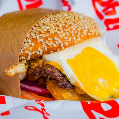 Breakfast Burger topped with fried egg, close-up.